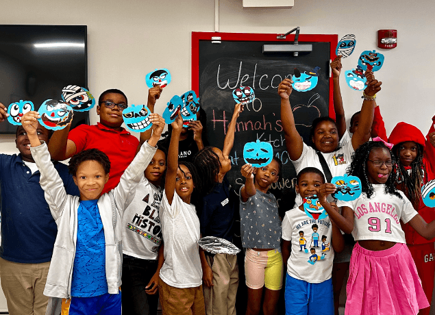 Group of kids with teal pumpkin made of craft paper